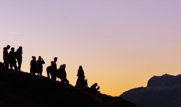 silhouette of group of people on hill
