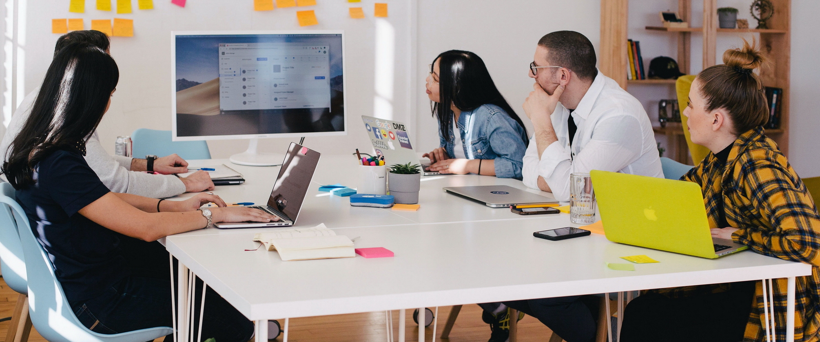 Small team meeting and using computer display