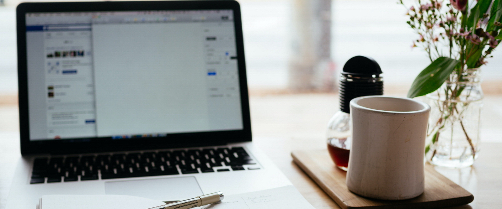 Laptop, book and cup on desk