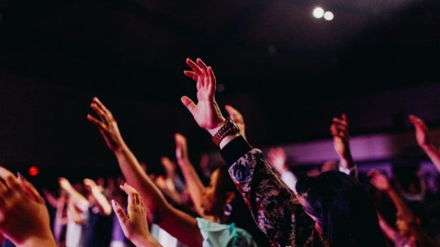 people raising their hands up