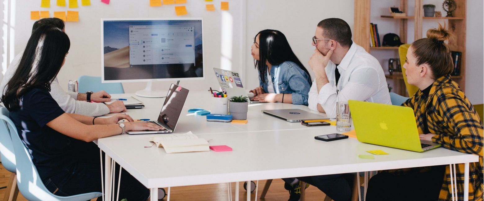 Small team meeting and using computer display